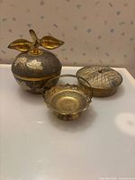 All three brass pieces grouped together