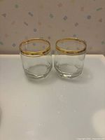 Both clear faceted lowball tumblers side by side