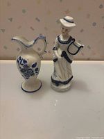 Pitcher and figurine side by side showing scale, color and style