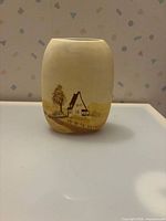 Full view of vase front showing landscape painting