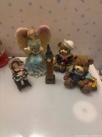 Group shot of five figurines on surface