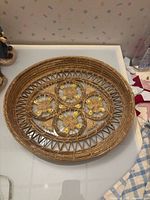 Top view of round wicker tray showing full design and shells
