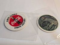 Fronts of Coca-Cola and Taco Bell zebra pogs