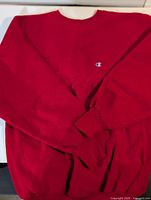 Front view of red Champion Reverse Weave sweatshirt showing overall condition and logo