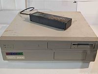 Front view showing computer case, floppy drive, and switchbox module on top