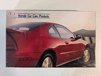 Front of sealed Honda Car Care Products box featuring red Honda vehicle