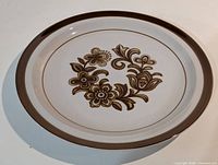 Top view of MI Japan stoneware dinner plate with brown floral design