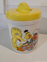 Full view of jar showing lid and character graphics