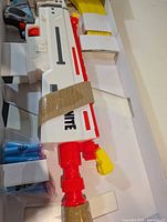 Blaster, clip, darts secured in packaging