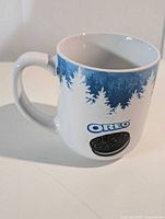 Left side view of Oreo ceramic mug showing graphic and handle