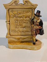 Front view showing plaque text and attached colonial figure