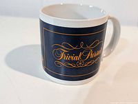 Side view showing Trivial Pursuit logo on navy panel