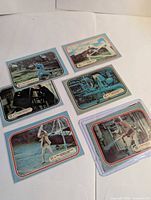 Six Bionic Woman trading cards and stickers front views laid out on flat surface