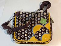 Front view of Vera Bradley Slate Blooms messenger bag displaying pattern, trim and strap