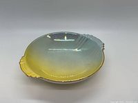 Top view of iridescent shell dish gradient yellow blue gold trim