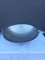 Top view of carbon steel wok showing interior surface and both side handles