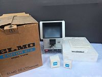 Overall lot showing editor, box, styrofoam, manual, spare bulb boxes