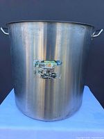 Front exterior view of stainless stock pot with label remnants
