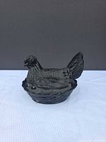 Front view of black glass hen on nest dish assembled
