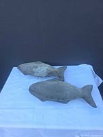 Two cast metal fish shaped dishes top view