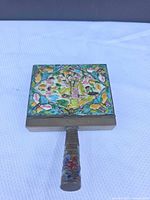 Top view of square cloisonné enamel lid showing female figure, butterflies, and floral motifs