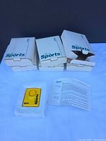 Three PAAL Sports boxes, one alarm unit in plastic tray, instruction sheets visible