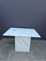 Front view of marble coffee table showing top and pedestal base