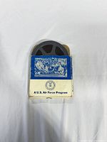 Front of blue-white box with reel partially inserted