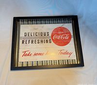 Front view of framed Coca-Cola wall sign showing design and frame