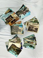 Stacks of colour postcards viewed from front showing assorted landmark scenes