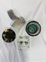 Top view of lighter and three ashtrays showing overall design and colors