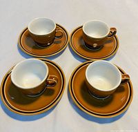 Top view of four cups on saucers showing color and style