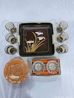 Top view of all items: tray center, six tumblers, amber bowl, boxed candle holders
