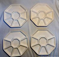 top view of four octagonal white divided platters