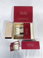 Open box with question card stack, lid and inserts visible