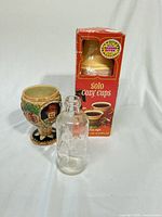 Front view of goblet, bottle and Solo Cozy Cups box