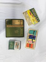 Overall view of bridge set box, single deck, candle coasters box, terry coasters box