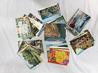 Fronts of assorted multicolor travel postcards spread in groups