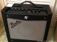 Front view of Fender Mustang 1 amplifier showing the Fender logo, grill, and part of the control panel.