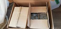 Boxed glass trinket boxes partially visible inside a cardboard box, showing overall lot quantity and packaging.
