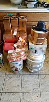 Full view of all items including canisters, breadbox, ice cream maker, double boiler, jelly molds, and floral tin canister on kitchen floor.