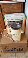 Photo of the new in box American Harvest food dehydrator outside the box, beige and transparent components visible.