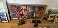 Photo showing the two wooden wine racks and the large framed print with a still life scene.