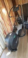 Full side view of Precor EFX5.23 elliptical showing housing, frame, foot pedals and handles