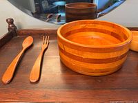 Large bowl with serving spoon and fork displayed on tray