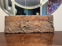 Full view of copper wall plaque on table