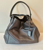 Front view of Coach metallic silver pebbled leather hobo tote