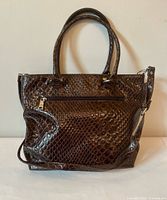 Front view of La Diva dark brown patent faux-croc handbag showing overall style, texture, handles and shoulder strap