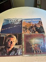 Front covers of all four albums displayed