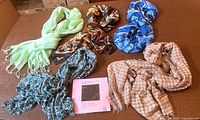All six scarves laid out on table